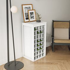 a room with a chair, lamp and wine rack on the floor next to it