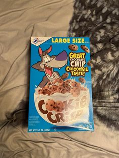 a cereal box sitting on top of a bed