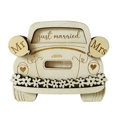 a wooden car with the words just married on it's front and flowers in the back