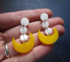 "Pretty Soldier Sailor Moon Cosplay Earrings are made of laser cut yellow acrylic and white acrylic. ★ Super lightweight and perfect for detailed cosplay, these dangle pendants are secured upon your choice of studs. Pick from: ~Nickel Free (Shown) ~Stainless Steel ~Plastic Studs ~Clip Ons ~Titanium Studs ★ Costume Jewelry pendants measure just under 1.5\" long and .75\" wide each. ★ Fighting evil by moonlight, wining love by daylight. Never running from a real fight! She is the one named Sailor Handmade White Plastic Earrings, White Moon-shaped Earrings For Pierced Ears, Detailed Cosplay, She Is The One, Moon Cosplay, Sailor Princess, Sailor Moon Cosplay, Princess Cosplay, Usagi Tsukino