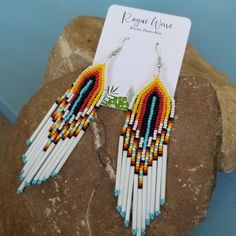 Bright seed bead earrings with sunrise pattern. They measure approximately 4.5 inches from drop. Very light and comfortable, featuring long premium glass seed beads.  Handmade by Roguewave in Puerto Rico. Presented on custom palm earring card so it is gift ready for that special person, of course that includes you too! Gracias por su visita! Free and fast shipping via USPS! Artisan White Earrings With Beaded Fringe, White Beaded Fringe Jewelry For Crafting, Beach Heishi Beaded Earrings, Handmade White Heishi Beads Earrings, White Southwestern Beaded Earrings For Festivals, Southwestern White Beaded Earrings For Festival, White Southwestern Style Beaded Earrings For Festival, Southwestern Handmade Earrings For Beach, Adjustable Heishi Beads Earrings For Beach