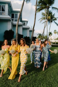 the bridesmaids are walking down the grass together