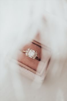 While listening to the song "1922", by the band Box the Oxford, Sarah was inspired to create this amazing collection. So of course, we had to name a ring after them! Our Oxford 14k gold ring rocks a vintage vibe while being thoroughly modern. The brilliant emerald cut 1 ct center stone sets the architectural tone, while the .17 ct tapering side baguette and round diamonds make this stunner truly sing. Fine Jewelry Emerald Cut Diamond Ring With Baguette Diamonds, Fine Jewelry Emerald Cut Rings With Baguette Diamonds, Emerald Ring With Baguette Diamonds And Asscher Cut, Fine Jewelry Diamond Ring For Proposal With Baguette Cut, Emerald Cut Moissanite Ring With Baguette Diamonds, Diamond Ring With Baguette Diamonds For Proposal, Emerald Cut Diamond Cluster Ring For Proposal, Emerald Cut Rings With Side Stones For Gift, Emerald Asscher Cut Ring With Baguette Diamonds For Wedding