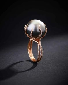 This ring perfectly encapsulates the ethereal beauty of a Tahitian pearl, renowned for its luminous sheen and captivating allure. This one-of-a-kind ring is not just a jewelry piece but a work of art. Cradling the pearl are delicate crescents of rose gold, reminiscent of the tender arms of a crescent moon, each meticul Luxury Formal Rings With Pearl Drop, Unusual Rings Pearl, Right Hand Rings Pearl, Luxury Round Rings For Jewelry Making, Beautiful Jewelry Pearl, Unconventional Engagement Rings Pearl, Pearl And Diamond Ring Modern, Black Pearl Diamond Ring, Pearl High Jewelry Ring