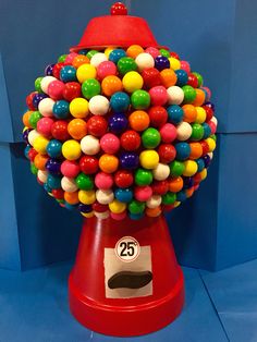 a gummy machine with lots of colorful balls on it's top and bottom