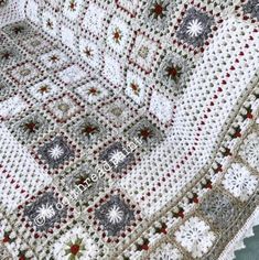 a crocheted blanket with snowflakes on it