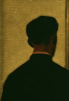 a man's shadow is shown in front of a wall