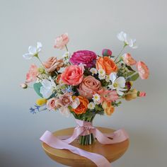 a vase filled with lots of different colored flowers