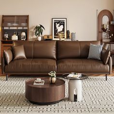 a living room with brown leather couches and coffee table in front of the window