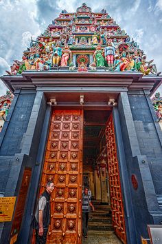 a man standing at the entrance to a temple