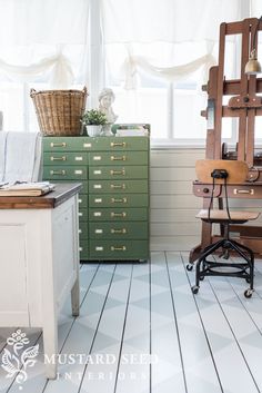 an old fashioned chair sits in front of a desk with drawers and a clock on it