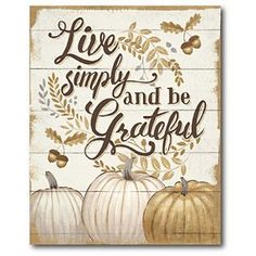 a wooden sign that says live simply and be grateful with three pumpkins on it