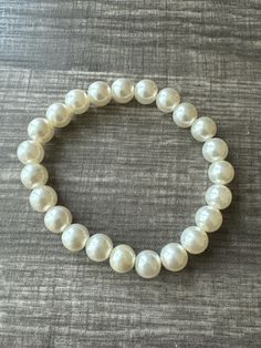 This bracelet is made with cream pearl beads. Note: Colors may vary depending on your monitor Shipping Info: All orders are shipped from Canada and they are sent through Canada Post.  If you would like expedited/faster shipping, it will cost more and you can reach out to me directly and I will give you pricing. Within Canada: Sent regular mail with no tracking and it can take 5-10 business days to arrive. United States: Sent with tracking and it can take 5-13 business days International: Sent In Pearl White Bracelets With 8mm Pearl Beads, Classic Stretch Bracelet With Pearl Beads, Pearl White Round Beaded Bracelets, Classic Pearl Stretch Bracelet Gift, Classic Pearl Stretch Bracelet As Gift, Classic Pearl Stretch Bracelet For Gifts, Pearl Beaded Stretch Bracelet, Pearl White Pearl Bracelet With 8mm Beads, Pearl White Beaded Stretch Bracelet