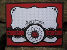 a red and white card with a ladybug on it