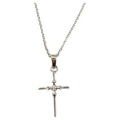 14K White Gold Diamond Cross Pendant Necklace - This beautiful diamond cross necklace features 1 round brilliant diamond. 1 round brilliant diamond totaling approx. 0.01ct. Total diamond weight approx. 0.01cts Diamond clarity - I1 Diamond color - H Chain Length: 18" Pendant size: approx. 19mm x 11mm 2.8 g / 1.8 dwt Stamped: RCI 14K INDONESIA Very good preowned condition. Just polished by our jeweler.  Will be shipped priority mail with insurance in a gift box. AD2/5/2024/17KCS