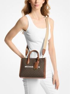 Whether you’re heading to a daytime event or simply running errands, the Mirella will meet the moment. Fit all your essentials into this charming mini tote, which can be carried by the top handles or worn crossbody thanks to a woven shoulder strap. Crafted from Signature logo-print canvas with our iconic lettering and charm, it’s a reliable way to spice up any outfit. Medium Bags With Detachable Strap For On-the-go, Chic Medium Satchel With Detachable Handle, Chic Medium Satchel With Top Carry Handle, Everyday Medium Shoulder Bag With Detachable Handle, Medium Everyday Shoulder Bag With Detachable Handle, Medium Shoulder Bag With Detachable Handle, Chic Medium Bags For On-the-go, Medium Satchel With Detachable Handle, Medium Bags With Detachable Handle