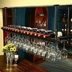 a wine rack filled with glasses on top of a wooden table