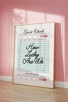 a poster with the words guest check on it in front of a pink painted wall