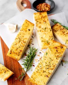 bread sticks with herbs and seasoning on a cutting board