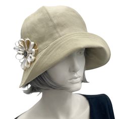 Polly wide front brim beige ,linen cloche hat with ribbon flower and button brooch Cream Gatsby Style Hat, Adjustable Cream Gatsby Hat, Elegant Bucket Hat For Spring, Elegant Spring Bucket Sun Hat, Cream Adjustable Gatsby Hat, Elegant Spring Bucket Hat, Chic Cloche Hat With Short Brim For Garden Party, Chic Cloche Hat For Garden Party With Short Brim, Chic Brimmed Cloche Hat For Garden Party