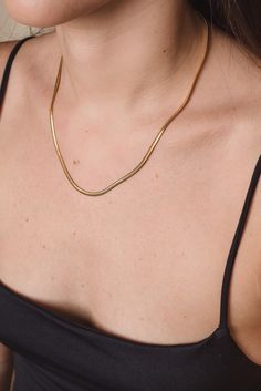 By HELOISE Wear this necklace as the perfect layer add on or just by itself to subtly accessorize! This necklace represents the delicacy and elegance in the modern women. Handmade by Colombian jewelers and artisans, this necklace is perfect for every soul. Materials: 24K gold plated bronze Length: 18 inches Width: 0.59 inches Closure: Lobster clasp Elegant Gold-tone Snake Chain Necklace As Gift, Everyday Gold-plated Snake Chain Necklace, Elegant Gold-tone Herringbone Necklace Gift, Modern Gold Plated Snake Chain Necklaces, Gold Snake Chain Jewelry For Layering, Gold Plated Clavicle Snake Chain Necklace, Gold Plated Snake Chain Necklace For Layering, Modern Gold Plated Snake Chain Necklace, Everyday Gold Delicate Snake Chain Necklace