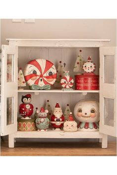 a shelf filled with lots of christmas ornaments and figurines on top of it