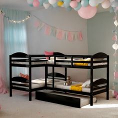 two bunk beds in a room with balloons hanging from the ceiling