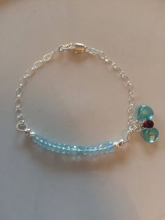 Clear sky blue aquamarine bracelet. These stones are facetted giving them tons of sparkle. All the other material is sterling silver. To the side there's two heart shaped apatite stones and one facetted teardrop rhodolite Garnet. All high quality gems. All stones are natural and untreated. This is 6-7 inches in length but I can add more loops. ABOUT SHIPPING- Shipping within Canada is crazy expensive. If there is any overage I will refund. I'm very limited in adding different cost of shipping be Blue Sterling Silver Gemstone Crystal Bracelet, Blue Bracelet With Gemstone Accents As Gift, Blue Bracelets With Gemstone Accents As A Gift, Blue Bracelets With Gemstone Accents For Gift, Blue Topaz Gemstone Bracelet As A Gift, Blue Topaz Gemstone Bracelet For Gift, Sterling Silver Teardrop Bracelet As Gift, Sterling Silver Bracelets With Blue Gemstone Accents, Blue Sterling Silver Bracelets With Gemstone Accents