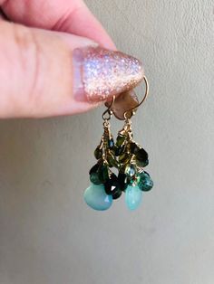 "Cluster earrings made of mixed green gemstones including green chalcedony, green tourmaline and chrome diopside. All the stones are drops/briolettes and wire wrapped with 14k gold filled wire. The chain and earwires are 14k gold filled as well. The cluster is made with smaller stones on top and graduate to larger stones on the bottom. The total length of the earrings is 1 3/4\". The actual drop measures 1 1/8\". These earrings may be dainty but the colors pack a punch!" Ombre Bracelet, Pearl Cluster Necklace, Peacock Pearl, Pink Pearl Necklace, Green Chalcedony, Pearl Cluster, Cluster Necklace, Cluster Earrings, Elegant Necklaces