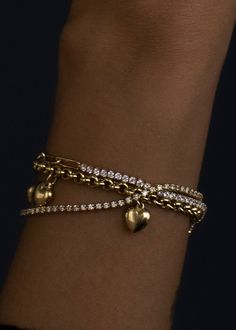 This piece features hollow puffed heart charms on a signature rolo chain bracelet. Wear it as your lucky charm and style with a vintage watch and tennis bracelet. 14k solid gold—alwaysAverage Weight: 5.3gWidth: 3.5mmLobster clasp closureHollow links and charms Classic Everyday Bracelets With Heart Charm, Elegant Everyday Heart Bracelet With Charms, Elegant Link Jewelry For Valentine's Day, Luxury Heart Charm Jewelry For Everyday, Luxury Everyday Jewelry With Heart Charm, Vintage Tarnish-resistant Bracelets, Tarnish Resistant Charm Bracelet For Anniversary, Classic Gold Charm Bracelet With Heart, Classic Heart Jubilee Bracelet For Valentine's Day