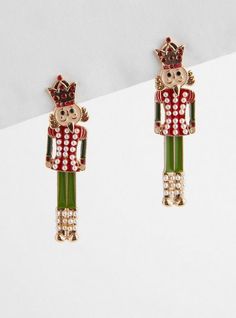 two pairs of earrings with an image of a nutcracker