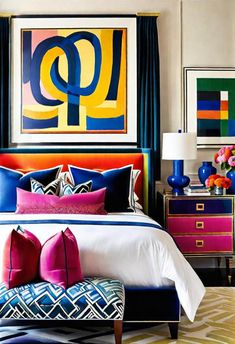 a bed with colorful pillows and art on the wall