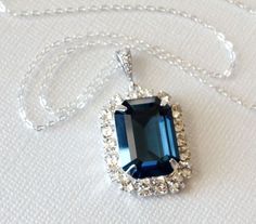 Navy Blue Montana Rectangle Halo Crystal Large Silver Wedding Pendant Necklace with .925 Sterling Silver Chain. PLEASE READ ITEM DESCRIPTION before placing your order, and contact me with any questions! CHAIN is 20 inches (50.8cm) long,  PENDANT is about 1.50 inch (3.5cm) long including bail. BRIDAL NECKLACES SECTION: https://www.etsy.com/shop/LanaChayka?ref=seller-platform-mcnav§ion_id=11638944 NECKLACES SECTION: https://www.etsy.com/shop/LanaChayka?ref=seller-platform-mcnav§ion_id=17026331 Glamorous and elegant, this necklace is perfect for weddings or special occasions such as birthdays, anniversaries, graduations, proms...or whatever you can imagine! Handmade necklace, is made with 18x13mm Montana Navy Blue pear shaped premium quality European rhinestone, .925 Sterling Silver 20 inches Blue Emerald Cut Gemstone Necklace, Elegant Rectangular Pendant Jewelry For Wedding, Formal Blue Crystal Jewelry, Blue Emerald Cut Necklace For Gift, Emerald Cut Blue Necklace As A Gift, Emerald Cut Blue Necklace For Gift, Rectangular Gemstone Necklace For Wedding, Elegant Blue Emerald-cut Jewelry, Blue Rectangular Pendant Jewelry For Formal Occasions