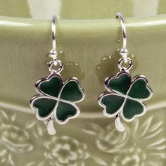 "Cute, simple and dainty green enamel shamrock charms dangle .5\" (1 cm) from sterling silver ear wires. ❖  enamel shamrock charms ❖  sterling silver ear wires ❖  rubber stoppers Earrings shown are on french hook ear wires. All earring types are sterling silver with the exception of clip-ons, which are silver plated. Hypoallergenic french hooks are stainless steel. ⊱✿ Matching necklace: https://kimsbling.etsy.com/listing/581261924/green-shamrock-and-swarovski-crystal?utm_source=Copy&utm_medium=ListingManager&utm_campaign=Share&utm_term=so.lmsm&share_time=1694811927737" Accessories Board, Shamrock Earrings, Green Clover, Purple Gift, Lucky Green, Clover Charm, Clover Earrings, Clover Green, Green Enamel