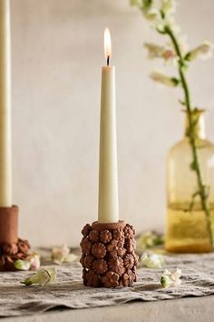 two candles sitting next to each other on a table