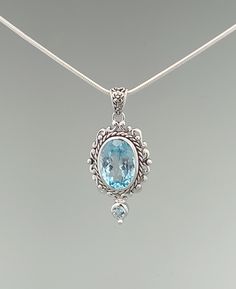 A large faceted blue topaz gemstone is housed inside a classic frame and further accented with a smaller blue topaz stone. Blue topaz is a calming stone associated with creativity and our inner truth. Sterling silver with premium rhodium plating Genuine blue topaz stones The pendant measures about 1.5" tall (including bail), and about 0.6" wide Sold as a pendant, the chain is sold separately Each stone is unique in its hues and tones About the Rhodium-Plated Sterling Silver: This design is made Elegant Light Blue Faceted Jewelry, Light Blue Sterling Silver Jewelry With Accent Stones, Classic Light Blue Sterling Silver Jewelry, Classic Light Blue Topaz Jewelry, Blue Topaz Oval Pendant Jewelry, Blue Topaz Faceted Jewelry, Elegant Turquoise Gemstones In Sterling Silver, Elegant Sterling Silver Gemstones With Large Stone, Elegant Blue Gemstones Set In Sterling Silver