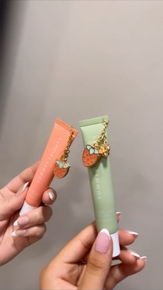 two hands holding small items in different colors