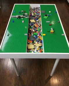 a table made out of legos on top of a hard wood floored floor