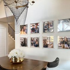 a dining room table with chairs and pictures on the wall above it, along with photos hanging on the wall