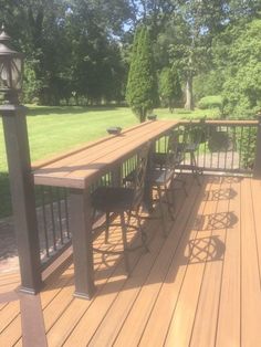 a wooden deck with chairs and table on it