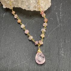 Faceted Morganite drop pendant is paired beautifully with Pink Topaz rosary style chain.The gorgeous faceted Morganite pendant has beautiful inclusions that help refract the light showing its inner sparkle. Combined with the Pink Topaz rosary style chain, make this a stunning necklace. The Pink Topaz stones have shades of light to darker pink with hints of yellow & peach. Finished off with lobster clasp and a gold filled dangle.Length: 16" with 2" extender.All jewelry comes packaged in gift box Briolette Faceted Beads Crystal Necklace Gift, Rose Quartz Faceted Beads Necklace Gift, Gift Rose Quartz Necklace With Faceted Beads, Gift Teardrop Faceted Bead Crystal Necklace, Dainty Briolette Faceted Crystal Necklaces, Teardrop Necklace With Faceted Beads For Gift, Dainty Faceted Briolette Crystal Necklace, Dainty Briolette Faceted Crystal Necklace, Teardrop Faceted Bead Necklace For Gift