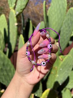 Evil Eye 🧿 Beaded Bracelet In many cultures, it is believed that evil eye bracelets protect against misfortune, evil looks and negative energy. Wear your bracelet for good luck and protection. ✨ Purple Evil eye boosts your imagination; Re-balances your life and removes obstacles. ✨ Evil Eye Bracelet Purple, Purple Evil Eye Bracelet, Violet Evil Eye Bracelet, Trendy Evil Eye Jewelry For Friendship, Trendy Evil Eye Beaded Bracelets For Festivals, Trendy Beaded Evil Eye Friendship Bracelet, Trendy Evil Eye Bracelet With Round Beads As Gift, Festival Spiritual Evil Eye Friendship Bracelets, Beaded Evil Eye Bracelet Gift