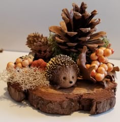 a hedgehog sitting on top of a tree stump surrounded by pine cones and berries