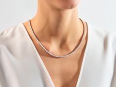 The Lab Diamond Tennis Necklace is a sophisticated and elegant piece of jewelry featuring lab-grown diamonds with a diameter of 3.00 millimeters. The necklace consists of a continuous string of these sparkling diamonds set in a delicate and classic tennis style, creating a timeless and glamorous accessory. Features Made to Order Gold Kt: 14K Solid Gold or 18K Solid Gold Gold Colors: Rose Gold, Yellow Gold, White Gold Gemstone: Lab Diamond Stone Cut: Round Stone Size: 3.00 mm Wide: 3.50 mm Color Minimalist Round Diamond Tennis Necklace, Formal Diamond White Lab Grown Diamond Tennis Necklace, Classic Lab Grown Diamond Tennis Necklace For Anniversary, Elegant Tennis Necklace With Single Cut Diamonds, Classic Tennis Necklace With Lab Grown Diamonds For Anniversary, Minimalist Diamond Tennis Necklace For Anniversary, Minimalist Brilliant Cut Tennis Necklace For Anniversary, Minimalist Diamond Cut Tennis Necklace For Anniversary, Minimalist Tennis Necklace With Brilliant Cut For Anniversary