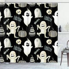 halloween shower curtain with ghost and pumpkins in black and white colors, hanging on a bathroom wall