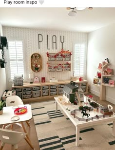 a play room filled with lots of toys and decor on the walls in front of windows