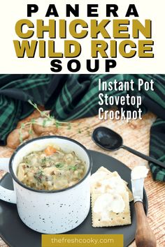 Image of mug filled with thick and creamy Copycat Panera Chicken & Wild Rice Soup with buttered saltines on the side.