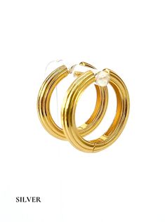 Introducing "Discotheque" golden hoops, meticulously crafted for a touch of glamour. Available in both small and large sizes, these earrings are adorned with the richness of 925 sterling silver and enhanced with lustrous 18k gold plating. The name captures the spirit of their playful yet sophisticated design, making them a statement piece that effortlessly elevates any ensemble. Step into the spotlight with the dazzling allure of Discotheque hoops. 925 Sterling Silver 18k Gold Plated Nickel Free & Hypoallergenic Golden Hoops, Adventure Style, Sophisticated Design, Holiday Collection, The Spirit, Gold Plating, Statement Pieces, 18k Gold, Gold Plate