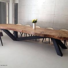 a long wooden table with chairs around it