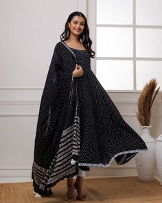 A simple yet alluring Black Mul Mul Polka Dot Anarkali Suit with Solid White Pants and a Dupatta is best for any occasion. The set comes with polka dot anarkali kurta has calf length, sleeveless and round neck teamed with white fully elasticated cotton pants and a mul mul dupatta with lace and tassels in the corner. No of Sets - 3 Color - Black Kurta Fabric – Mul Mul Work – Polka Dot. Sleeves-Sleeveless Slits - No Slits Length - Calf Length Bottom Fabric - Cotton with fully elasticated waistband Dupatta – Mul mul dupatta with lace & tassels detailing CARE: Gentle Hand Wash DISCLAIMER - The color of the product may be differ due to screen settings of device. Black Kurta, Formal Jewelry, Anarkali Kurta, Anarkali Suit, Churidar, Fabric Shop, White Pants, Cotton Pants, Formal Wedding